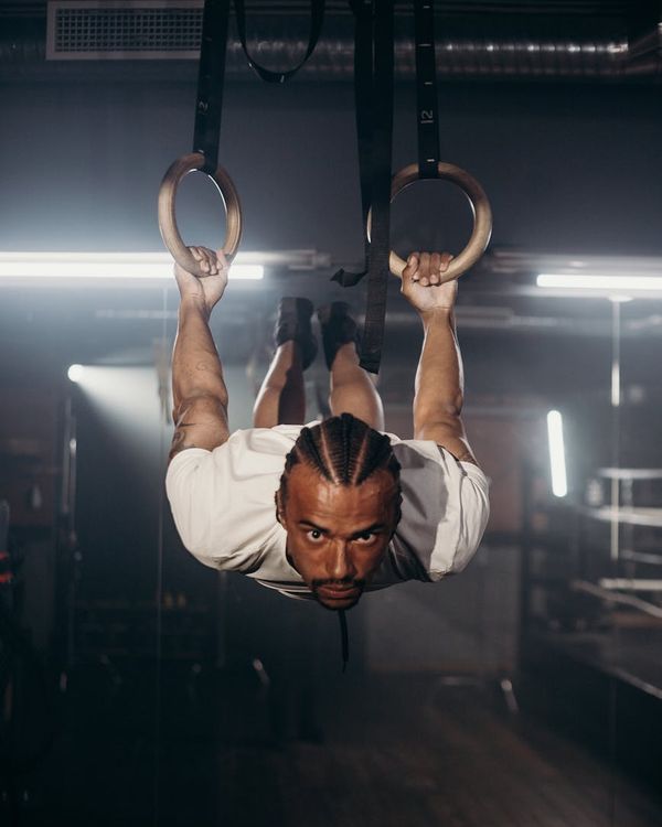 A focused man balancing during a core strength exercise.